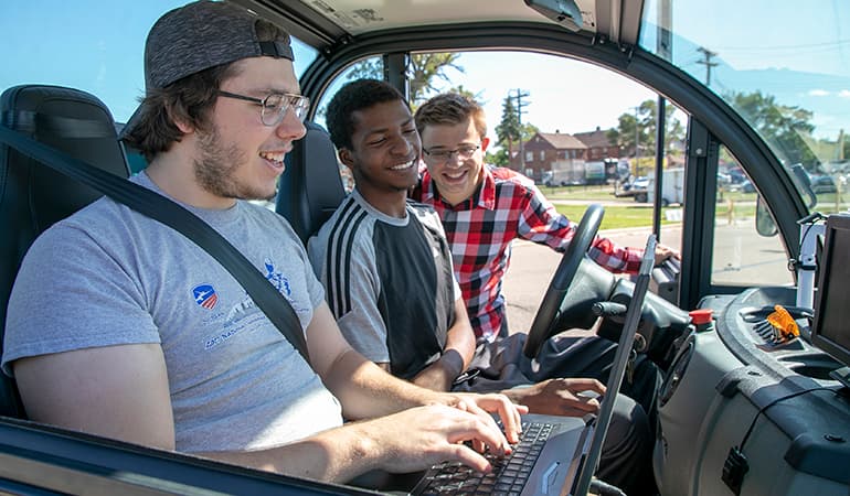 3 students at autonomous car project
