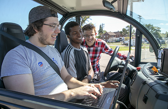 Students work on an autonomous vehicle