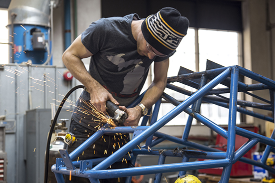 A Detroit Mercy student uses a welder on a project.