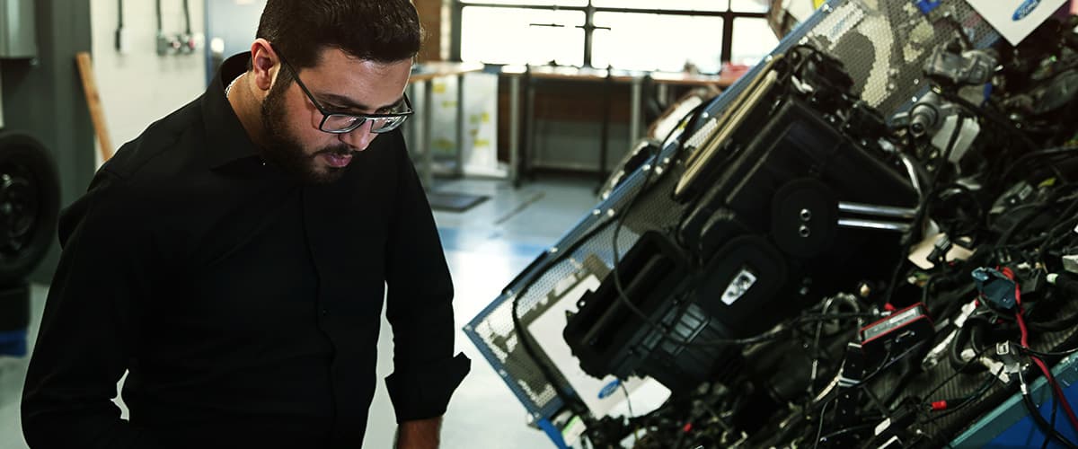 grad student working at engine in lab