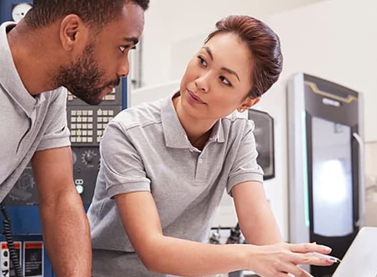 guy looking at girl pointing to computer