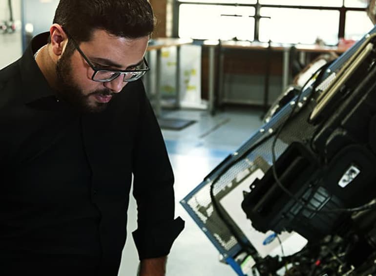 student working on electric car model