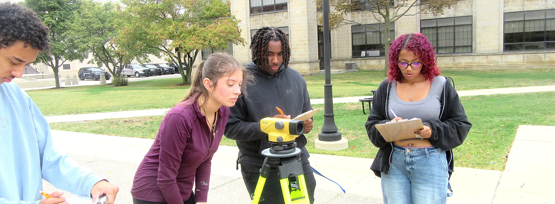 students using the level to determine ground surface elevations 