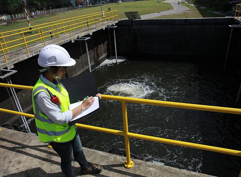 person standing at water treatment facility