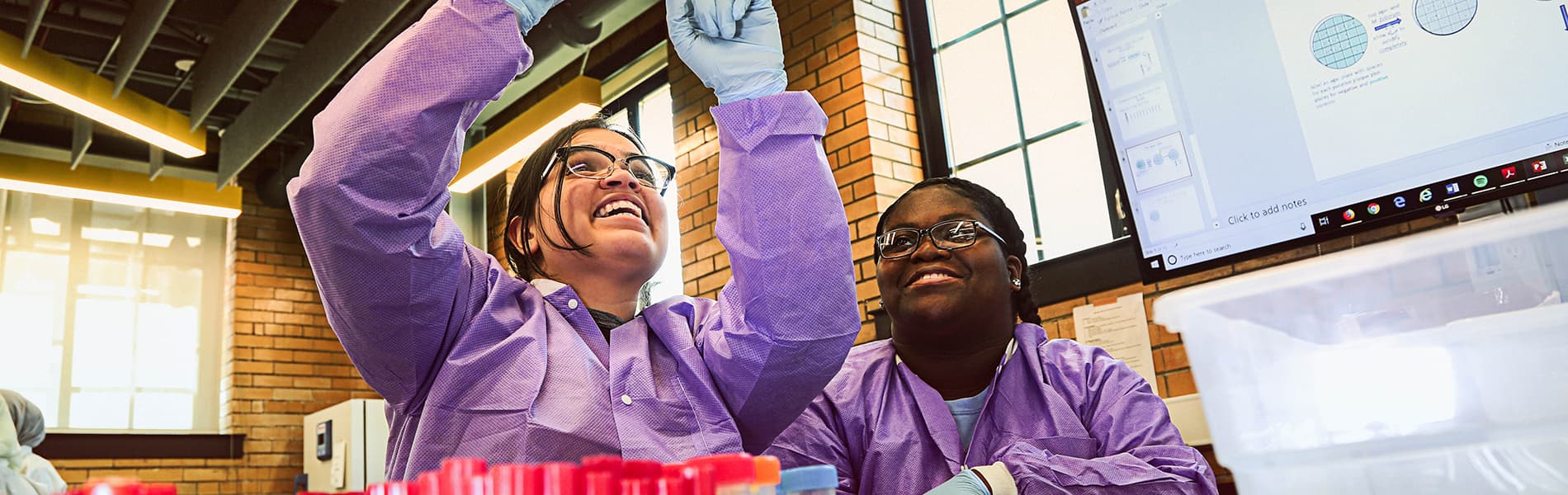 Two students looking at petri dish