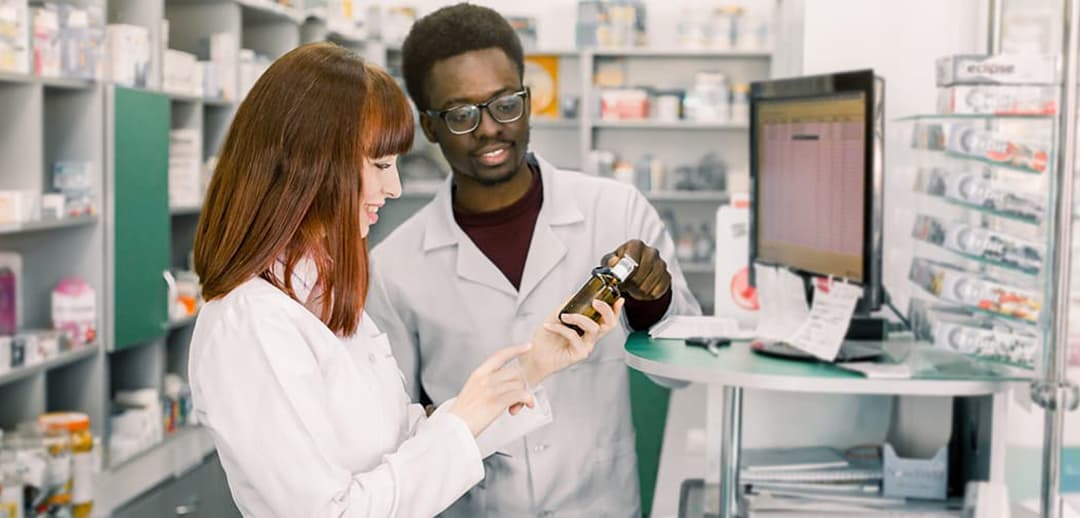 Student with pharmacist at a pharmacy