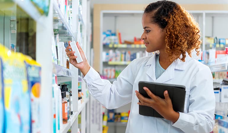 female pharmacists with bottle of meds