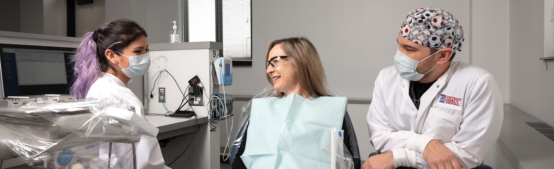 female and male student with dental patient