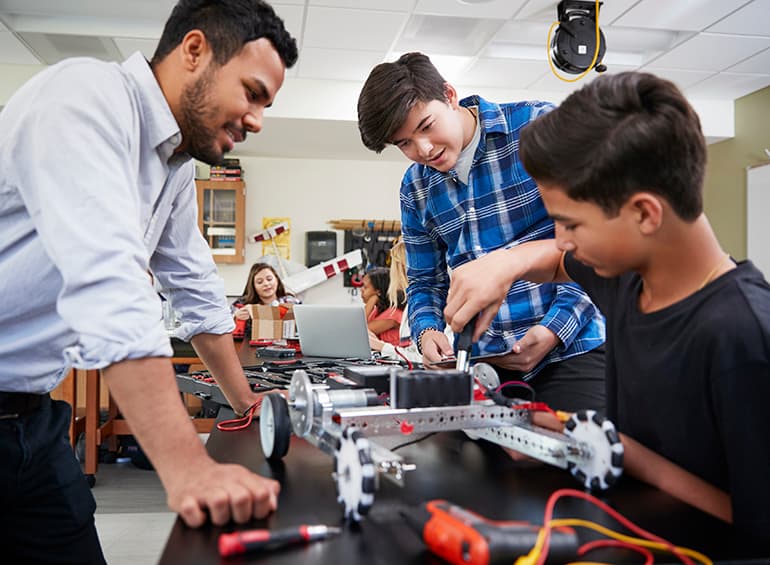 teacher with two students stem project